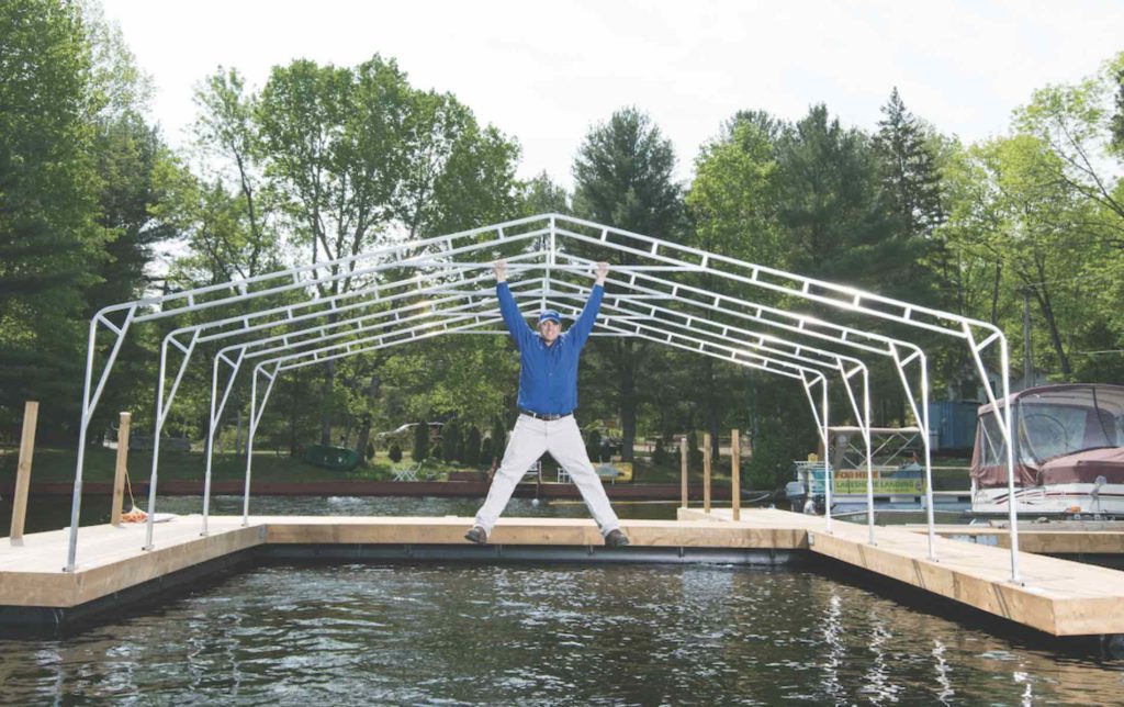 Aquadome made-in-Muskoka awnings with man hanging over water