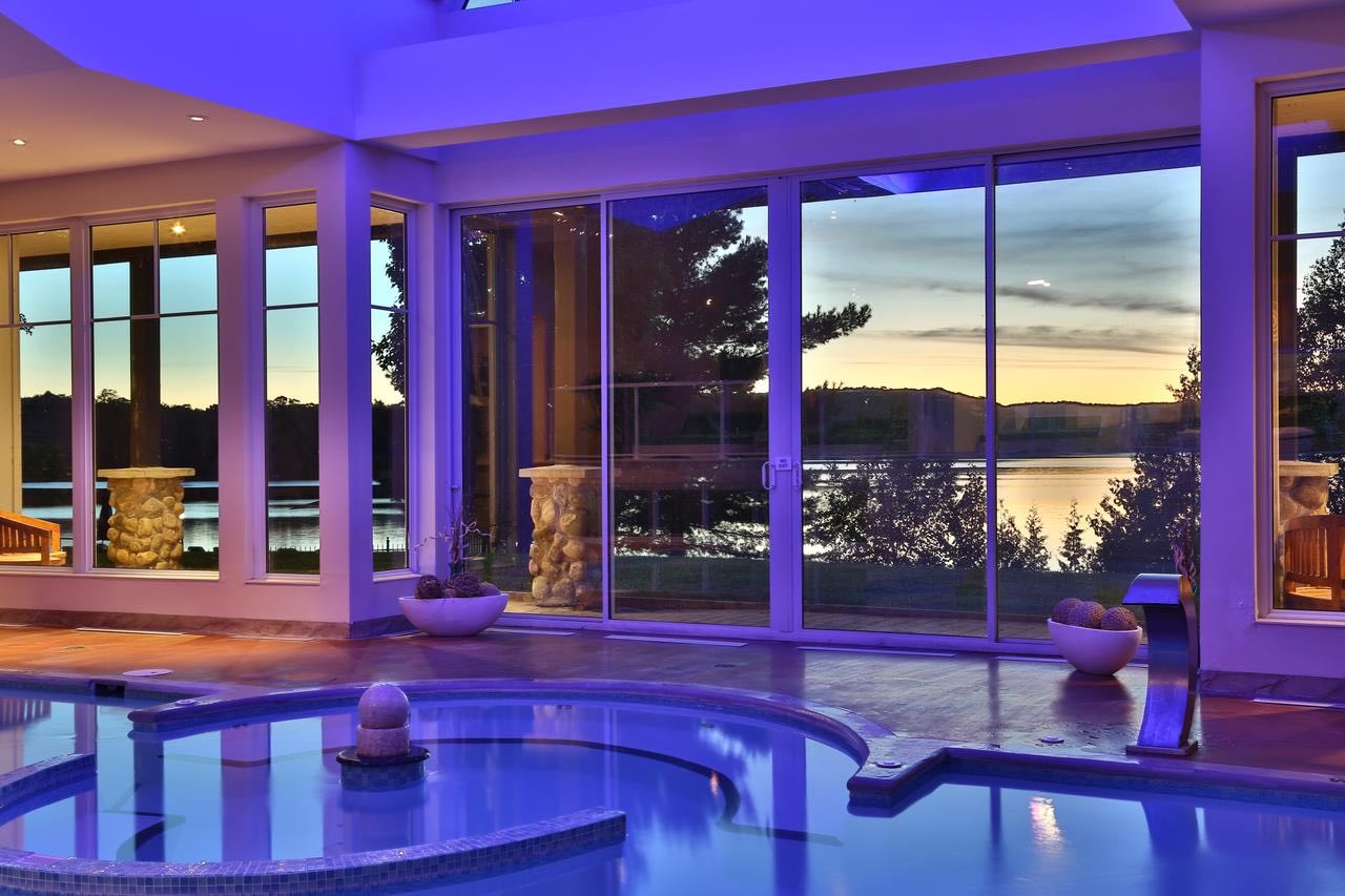 A stay at Sir Sams INn is one of the top things to do in Haliburton, with its elegant indoor pool shown here at dusk